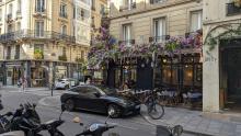 A Cafe in a Street of Paris with lots of Flowers